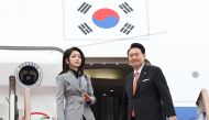 South Korea's President Yoon Suk Yeol (R) and his wife Kim Keon Hee (L) board their aircraft at Seoul Air Base in Seongnam on December 11, 2023, for a state visit to the Netherlands. Photo by YONHAP / AFP