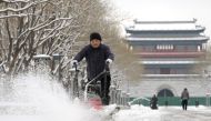 A worker removes snow with a machine at Yongdingmen Park in Beijing, capital of China, Dec. 11, 2023. Xinhua/Li He