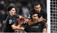 PSG’s Achraf Hakimi (centre) celebrates with teammates Kylian Mbappe (right) and Vitinha after scoring a goal against Borussia Dortmund in Paris. AFP