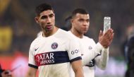 Paris Saint-Germain's French forward #07 Kylian Mbappe (R) and Paris Saint-Germain's Moroccan defender #02 Achraf Hakimi react after the UEFA Champions League group F football match between BVB Borussia Dortmund and Paris Saint-Germain in Dortmund, western Germany, on December 13, 2023. (Photo by FRANCK FIFE / AFP)
