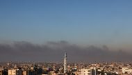 Smoke billowing over Khan Yunis in the southern Gaza Strip following Israeli bombardment on December 15, 2023. (Photo by Mohammed Abed / AFP)
