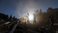 Palestinian youths check debris following Israeli bombardment on Rafah, in the southern Gaza Strip, on December 15, 2023. (Photo by Mohammed Abed / AFP)
 
