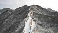 This photo shows an aerial view of a snow-covered section of the Great Wall of China at Shuiguan, north of Beijing, after an overnight snowfall on December 15, 2023. (Photo by Greg Baker / AFP)

