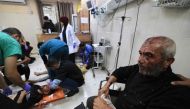 Medics treat Palestinians injured in Israeli bombardment, at Nasser hospital in Khan Yunis in the southern Gaza Strip on December 17, 2023. Photo by Mahmud HAMS / AFP