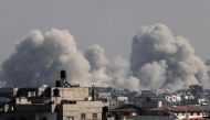 Smoke billows over Khan Yunis in the southern Gaza strip during Israeli bombardment on December 17, 2023. Photo by Mahmud HAMS / AFP