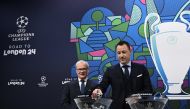 British former football player, John Terry (right) handles a draw ball alongside UEFA Deputy General Secretary, Giorgio Marchetti during the 2023-2024 UEFA Champions League Round of 16 draw in Nyon. AFP