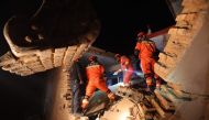 Rescue workers search a house for survivors after an earthquake in Kangdiao village, Dahejia, Jishishan County, in northwest China's Gansu province on December 19, 2023. Photo by AFP
