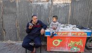 A Palestinian man listens to his radio in a refugee camp in Rafah in the southern Gaza Strip on December 19, 2023. (Photo by Mohammed Abed / AFP)
 