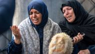Women mourn the loss of loved ones who were killed overnight during Israeli bombardment, at a hospital in Rafah in the southern Gaza Strip on December 19, 2023. Photo by MOHAMMED ABED / AFP