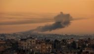 Smoke rises over Khan Yunis during Israeli bombardment in the southern Gaza Strip on December 19, 2023. (Photo by Said Khatib / AFP)