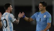 (FILES) Argentina's Lionel Messi (L) greets Uruguay's Luis Suarez before the start of the South American qualification football match for the FIFA World Cup Qatar 2022, at the Monumental stadium in Buenos Aires, on October 10, 2021. (Photo by Juan Mabromata / AFP)