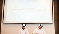 Abdulrahman Mohammed Talfat, Head of the Department of Qualifying Skills Development at the Ministry of Labour, and Mubarak Jassim Al Menkhis, Acting Group Head for Human Resources and Administration at QGRI, signing the agreement. 