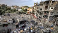 The aftermath of an overnight Israeli strike at al-Maghazi refugee camp on December 25, 2023. (Photo by Mahmud Hams / AFP)
 