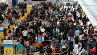 People queue at the check-in counters at Ninoy Aquino International Airport in Pasay, Metro Manila on December 22, 2023. Photo by JAM STA ROSA / AFP