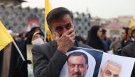 An Iranian mourns during the funeral of Razi Moussavi on December 28, 2023. (Photo by Atta Kenare / AFP)