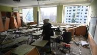 A teacher inspects her classroom that was damaged after a missile attack in Lviv, western Ukraine, on December 29, 2023, amid the Russian invasion of Ukraine. (Photo by Yuriy Dyachyshyn / AFP)