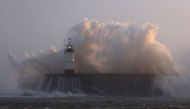 Waves crash over Newhaven Lighthouse and the breakwater in Newhaven on January 2, 2024, as Storm Henk brought strong winds and heavy rain across much of southern England. Photo by ADRIAN DENNIS / AFP