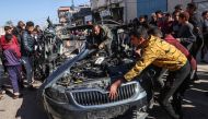 People check the car in which two journalists,Mustafa Thuria, a video stringer for AFP news agency, and Hamza Wael Dahdouh, a journalist with Al Jazeera television network, were killed in a reported Israeli strike in Rafah in the Gaza Strip on January 7, 2024. Photo by AFP