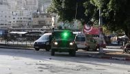 Israeli troops enter Nablus during a raid on the occupied West Bank city on January 10, 2024. (Photo by Zain JAAFAR / AFP)
