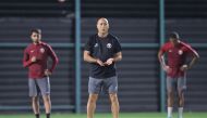 Qatar coach Marquez Lopez supervises team's training session.