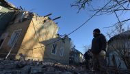 A man looks at a damaged two-storey housing block hit by recent shelling in Makiivka (Makeyevka), on January 12, 2024. (Photo by Stringer / AFP)
 