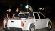 Prison officials who were being held hostage by inmates leave in a pick-up truck upon being released from Machala prison, in Machala, Ecuador, on January 13, 2024. (Photo by Ariel Suarez / AFP)
