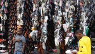 Pedestrians shop for shoes along the business district in Nairobi, on January 16, 2024. (Photo by SIMON MAINA / AFP)
