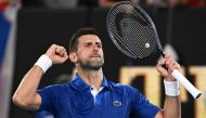 Serbia's Novak Djokovic celebrates after victory against Argentina's Tomas Etcheverry during their men's singles match on day six of the Australian Open tennis tournament in Melbourne on January 19, 2024. (Photo by WILLIAM WEST / AFP) 