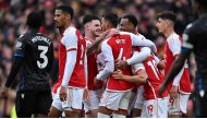 Arsenal's players celebrate their second goal scored by Crystal Palace's English goalkeeper #30 Dean Henderson (unseen) during the English Premier League football match between Arsenal and Crystal Palace at the Emirates Stadium in London on January 20, 2024. (Photo by Ben Stansall / AFP) 