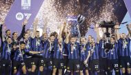 Inter Milan’s players celebrate with the trophy. AFP 