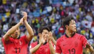South Korea’s players applaud the fans after the match against Malaysia, yesterday. AFP