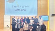 A group photo of the QU students, professors and officials.