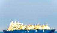 Blue coloured hull large liquefied natural gas (LNG) carrier with 4 LNG tanks sails along the sea.