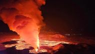 Billowing smoke and flowing lava are seen pouring out of a new fissure in this Icelandic Department of Civil Protection and Emergency Management , February 8, 2024, handout image during a new volcanic eruption on the outskirts of the evacuated town of Grindavik, western Iceland. Photo by Icelandic Department of Civil Protection and Emergency Management / AFP