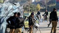 Policemen stand guard in Peshawar on February 9, 2024, a day after Pakistan's national elections. (Photo by Abdul MAJEED / AFP)
