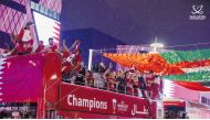 Qatar players and officials celebrate during the victory parade at the Lusail Boulevard. 