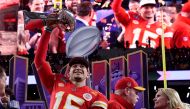 Kansas City Chiefs' quarterback #15 Patrick Mahomes celebrates with the trophy after the Chiefs won Super Bowl LVIII against the San Francisco 49ers at Allegiant Stadium in Las Vegas, Nevada, February 11, 2024. (Photo by TIMOTHY A. CLARY / AFP)
