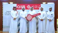 QIIB CEO, Dr Abdulbasit Ahmad Al Shaibei giving the key to the luxurious apartment at Seef Lusail to Qahtan Salem Al Karbi, brother of the winner Arwa Salem Al Karba.
