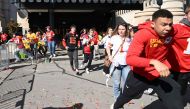 People flee after shots were fired near the Kansas City Chiefs' Super Bowl LVIII victory parade on February 14, 2024, in Kansas City, Missouri. (Photo by ANDREW CABALLERO-REYNOLDS / AFP)
