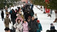 People visit the Temple of Heaven after snowfall in Beijing on February 21, 2024. (Photo by WANG Zhao / AFP)