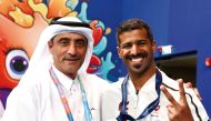 Qatar's Mohammed Shewaiter celebrates his gold medal with Director General of the Doha 2024 Local Organising Committee Khaleel Al Jaber.
