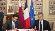 Minister of Interior and Commander of the Internal Security Force (Lekhwiya) H E Sheikh Khalifa bin Hamad bin Khalifa Al Thani (left) and French Minister of Interior and Overseas Territories H E Gerald Darmanin sign a document.