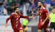 Al Markhiya’s Driss Fettouhi (right) celebrates with Mohamad Al Abbasi after scoring a goal against Al Wakrah at the Al Janoub Stadium, yesterday. 