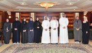 QIIB’s Head of Human Resources and Administrative Affairs, Ali Hamad Al Mesaifri; QIIB’s Head of Business Development, Khaled Abdul Rahman Al Shaibei pose for a group photo with students.