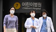 Medical workers walk outside a children's hospital in Seoul on March 11, 2024. (Photo by ANTHONY WALLACE / AFP)