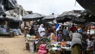 People shop at the market in Abobo, a suburb of Abidjan on March 14, 2024. (Photo by Issouf SANOGO / AFP)
