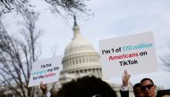 Participants hold signs in support of TikTok outside the U.S. Capitol Building on March 13, 2024 in Washington, DC. (Photo by Anna Moneymaker / GETTY IMAGES NORTH AMERICA / Getty Images via AFP)
