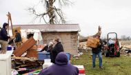 Families and neighbors help each other clean up after a tornado struck the area on March 15th, 2024 in Indian Lake, Ohio. The storms caused casualties, resulting in deaths, and left many people without homes. (Photo by Andrew Spear / GETTY IMAGES NORTH AMERICA / Getty Images via AFP)

