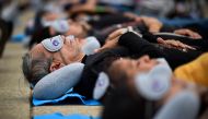 People enjoy a nap while attending the World Sleep Day event at the Monumento a la Revoluciَn in Mexico City, Mexico, on March 15, 2024. (Photo by Rodrigo Oropeza / AFP)