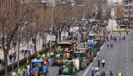 Farmers drive their tractors during a protest organised by 
